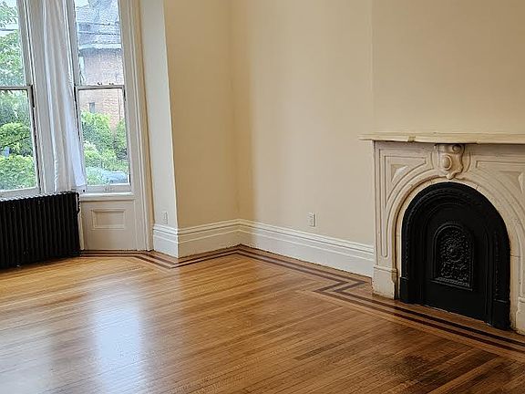 The Carrara marble fireplace is one of three in the newly-renovated duplex.