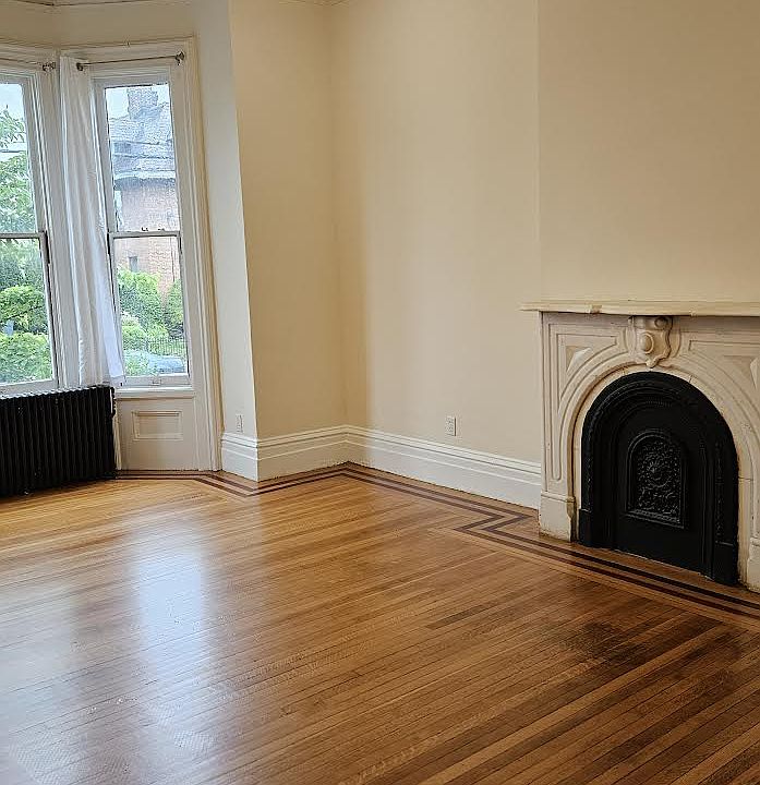 The Carrara marble fireplace is one of three in the newly-renovated duplex.