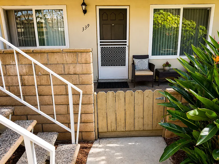 Welcoming front entry with gated patio area and convenient access to the unit.