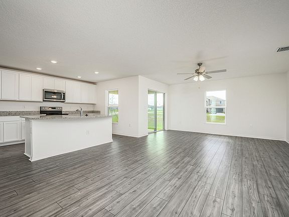 The kitchen has a large island that overlooks the entertainment space
