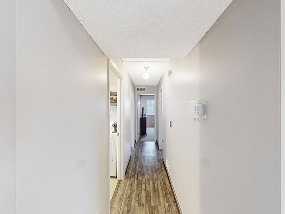 Hallway that takes you the rooms and laudry room.