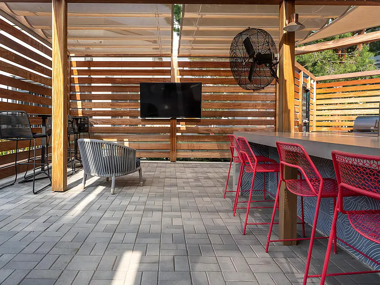 Outdoor Kitchen with Bar Seating, Flat-Screen TV, and Ceiling Fan