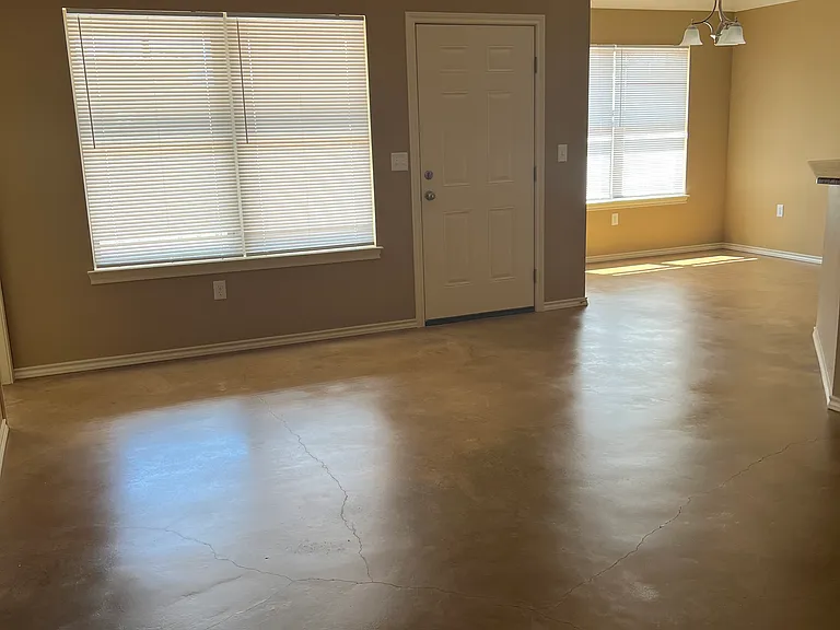 Living room view from entry hall. Dining in the corner.