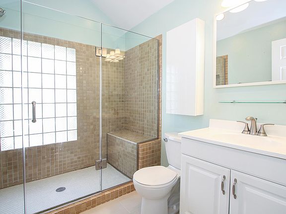 Beautiful upstairs bathroom with natural light, high ceiling and delightful stonework.