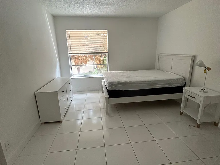 2nd bedroom with queen bed, night stand, and dresser