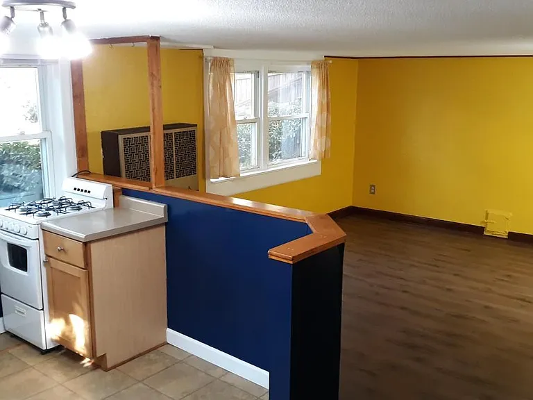 Kitchen opens into living room. Laminate flooring.