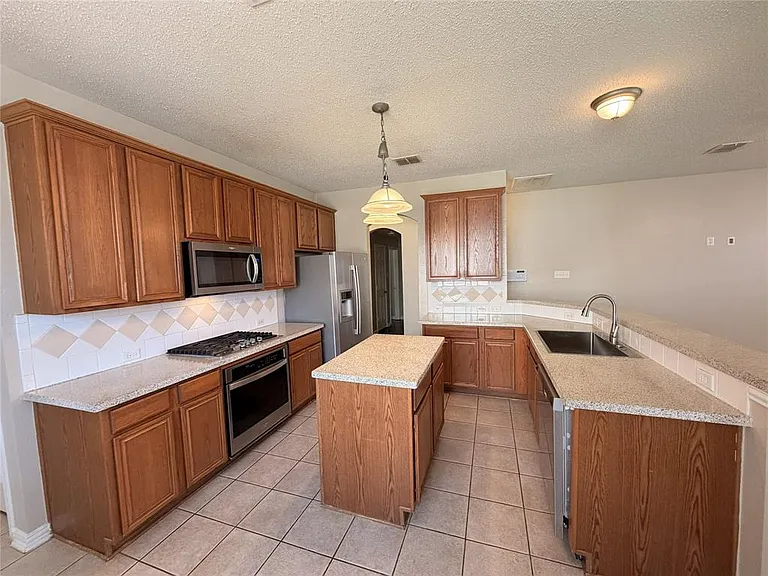 NICE SPACIOUS KITCHEN WITH AMPLE 42" CABINETS AND AN ISLAND.