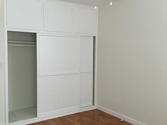 Bedroom with ample closet and storage space.