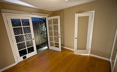 Middle bedroom or office with french doors to the side yard.