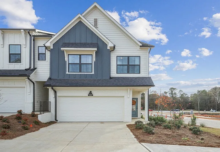 Exterior of the Pettit, two story home with a private driveway and attached garage.