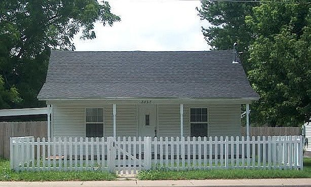 Front View of Home - Covered Porch - Fenced Yard - Carport