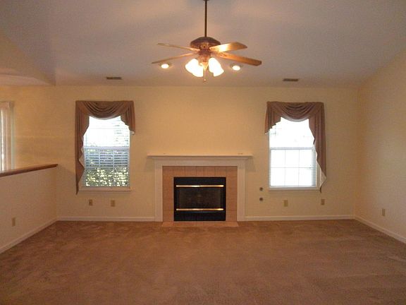 Living room with cathedral ceiling and fireplace