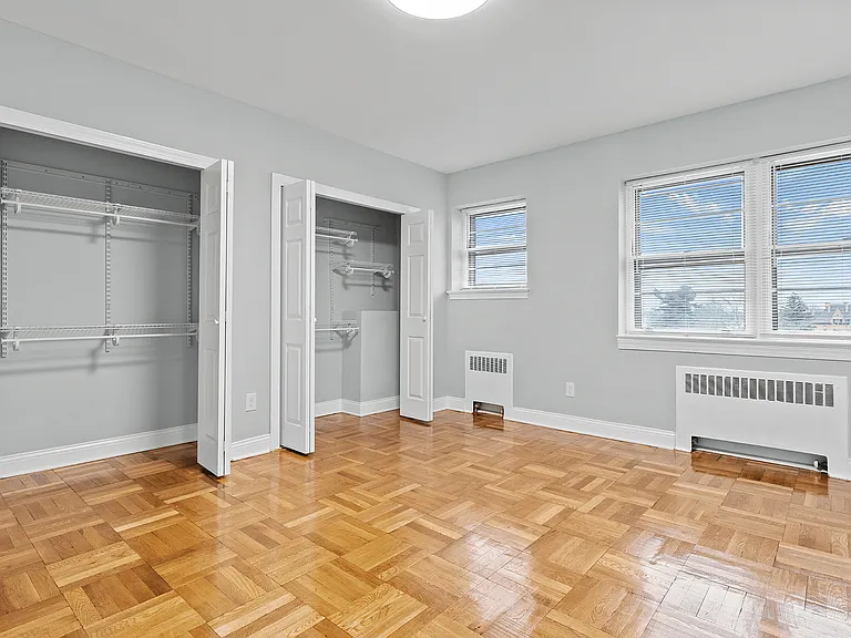 Step into this airy bedroom featuring elegant parquet floors and abundant closet space.