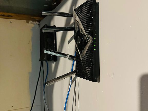 Dedicated utility area featuring wall-mounted networking equipment, ideal for maintaining a strong and organized internet connection throughout the home.