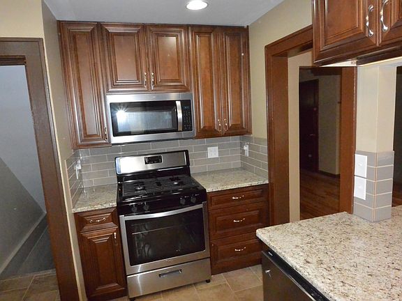 Gas stove and built in microwave. Lots of storage in these floor to ceiling cabinets. Plenty of wall plugs too.