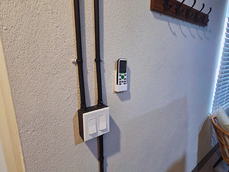 Convenient wall-mounted A/C control for personalized comfort.