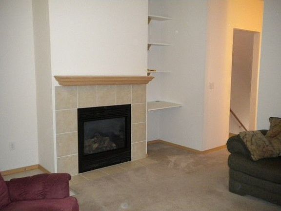 In winter, you can cuddle up by the gas fireplace. to the right, a computer cubby with book shelves 