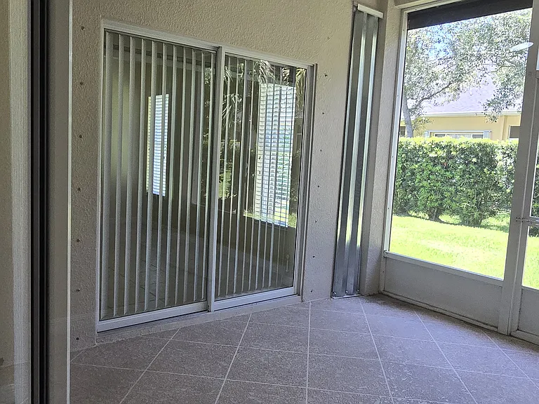 Screened Lenai with Primary Bedroom Slider viewed from Living Room Slider