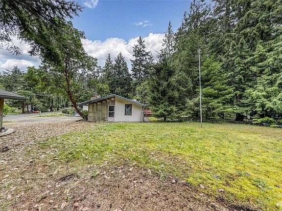 Looking at the side of the home from the south side of the yard.  >