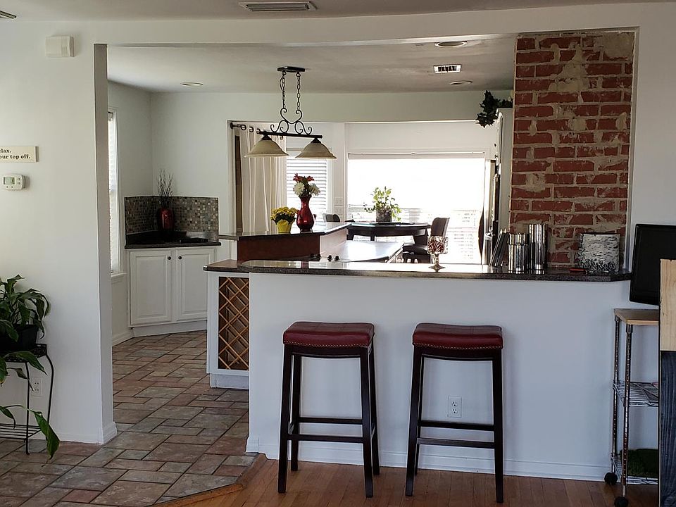 From living room looking into kitchen- bar for 2 stools & kitchen island seats 3-4 more