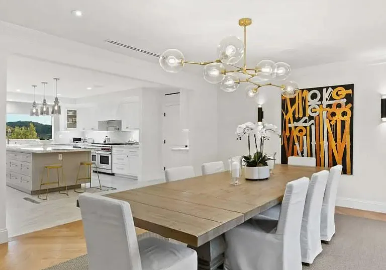 Large wooden dining table with raised chairs is perfect for indoor dining occasions.