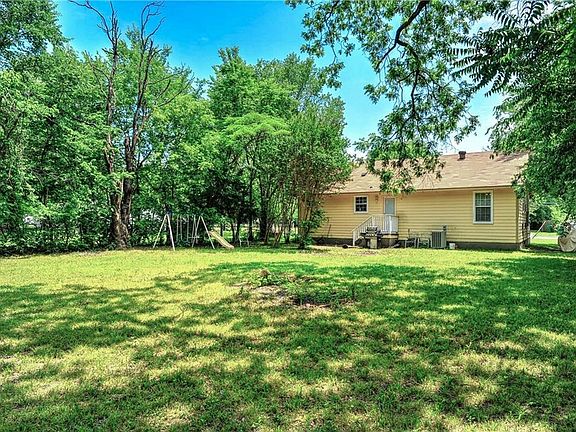 Large shady back yard is fully fenced.