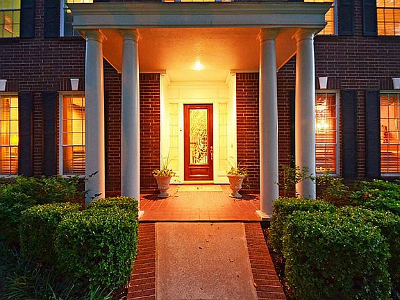 THE ENTRY IS ENHANCED BY A WELCOMING COVERED PATIO!