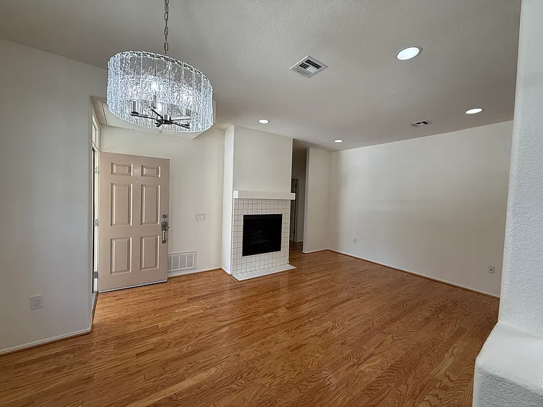 Living room, dining area and fireplace.