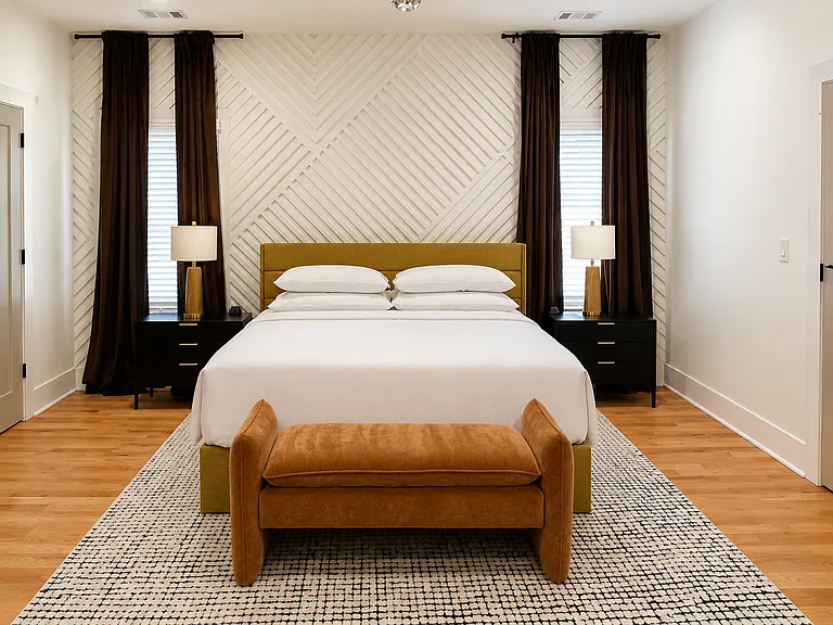 The Edgewood Suite is spacious primary king room with smart TV, blackout curtains, bedside charging, private work station, designer decor, 2 closets & plush bedding offering a self-contained escape & elevated night's sleep.