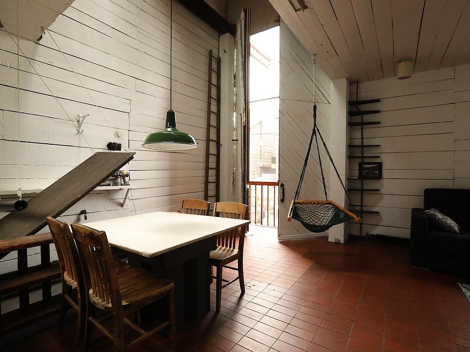 solid marble dining table and chairs come with the place. big doors open with full height insect screen. hatch door to basement to the left.