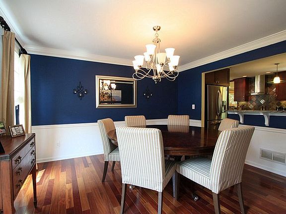 Spacious dining room with chair rail. Opens to kitchen.
