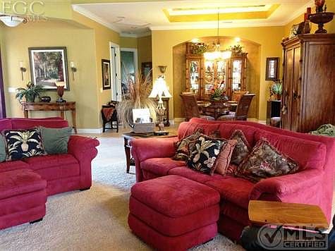 Open & airy family room, just a step away from the sliding glass doors, leading out to the pool.