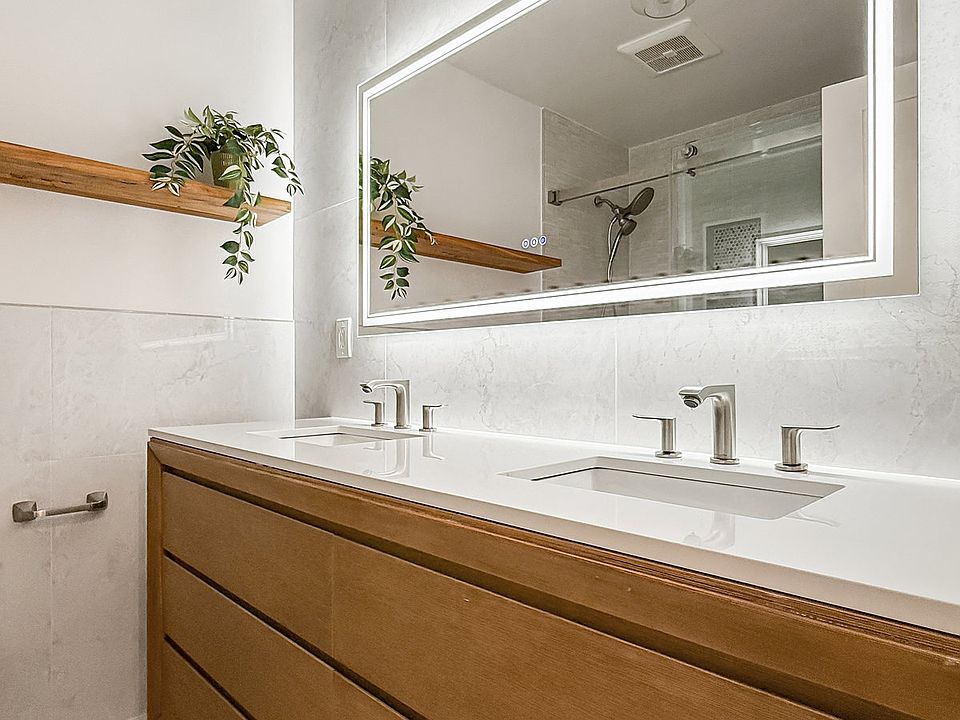 main bath with double vanity and large LED mirror