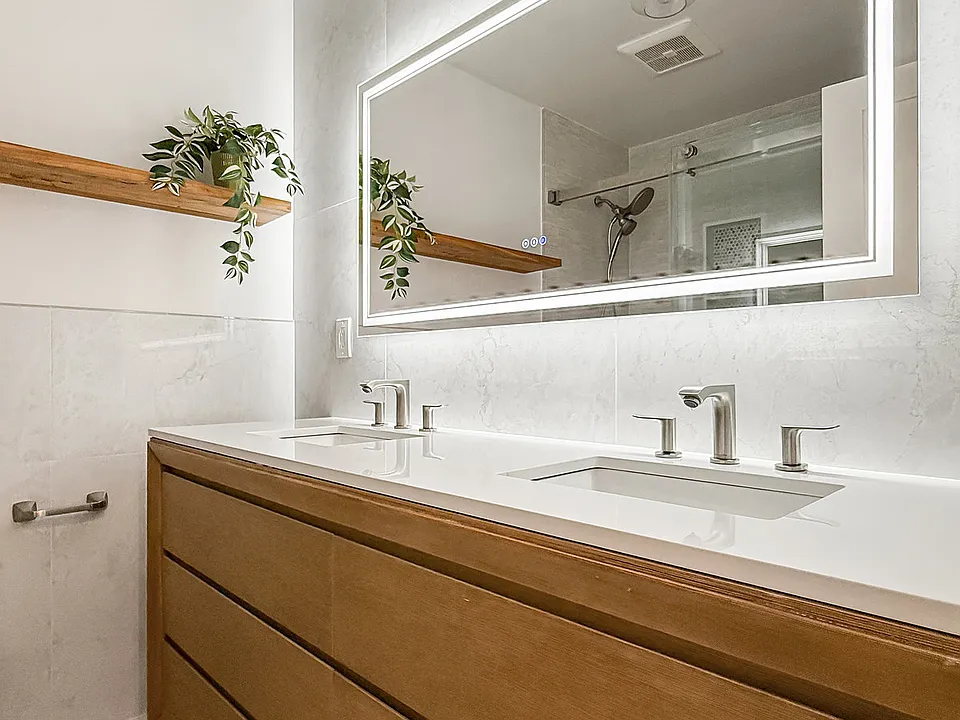 main bath with double vanity and large LED mirror