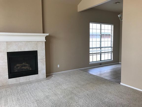 Fireplace (with gas insert) in vaulted living looking into dining room.