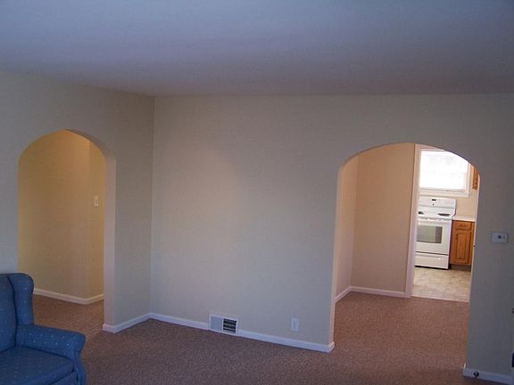 Gracefully arched doorways lead from the spacious living roo