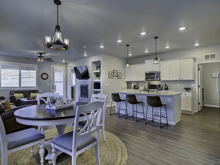 Large kitchen with stainless steel appliances, granite countertops, an island with three barstools, and all the essentials for your extended stay!