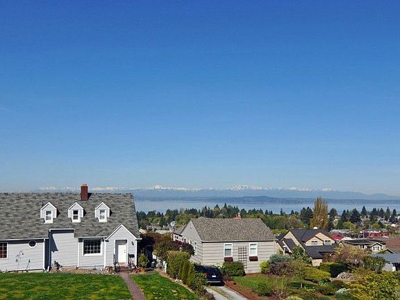 This photo, taken from simply standing on the front entry steps, gives you a sense of the wide and unobstructed view coming in the living room and dining room windows. Note the absence of power lines!