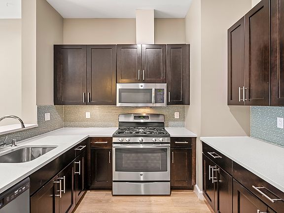 Kitchens feature stainless steel appliances and quartz countertops