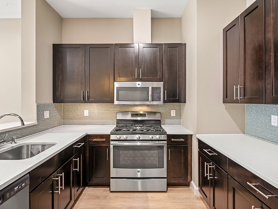 Kitchens feature stainless steel appliances and quartz countertops