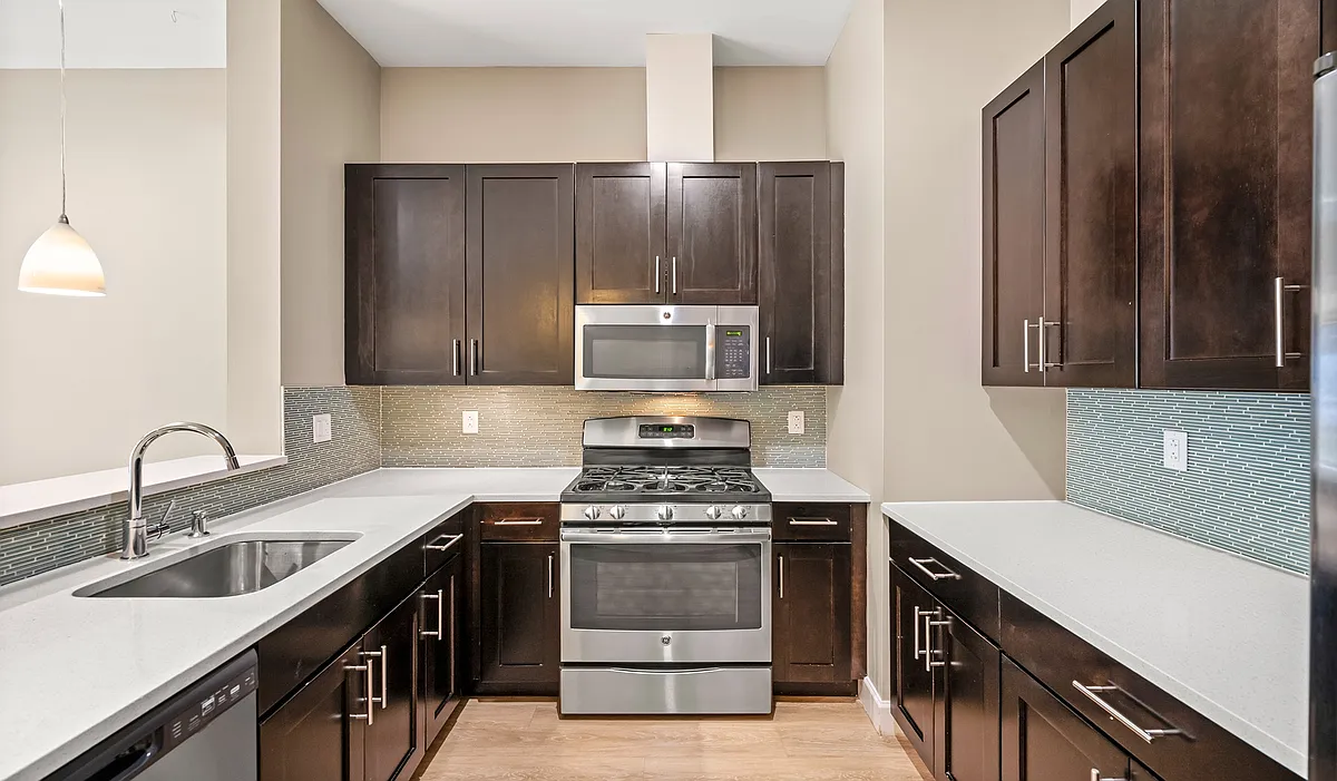 Kitchens feature stainless steel appliances and quartz countertops - Axiom