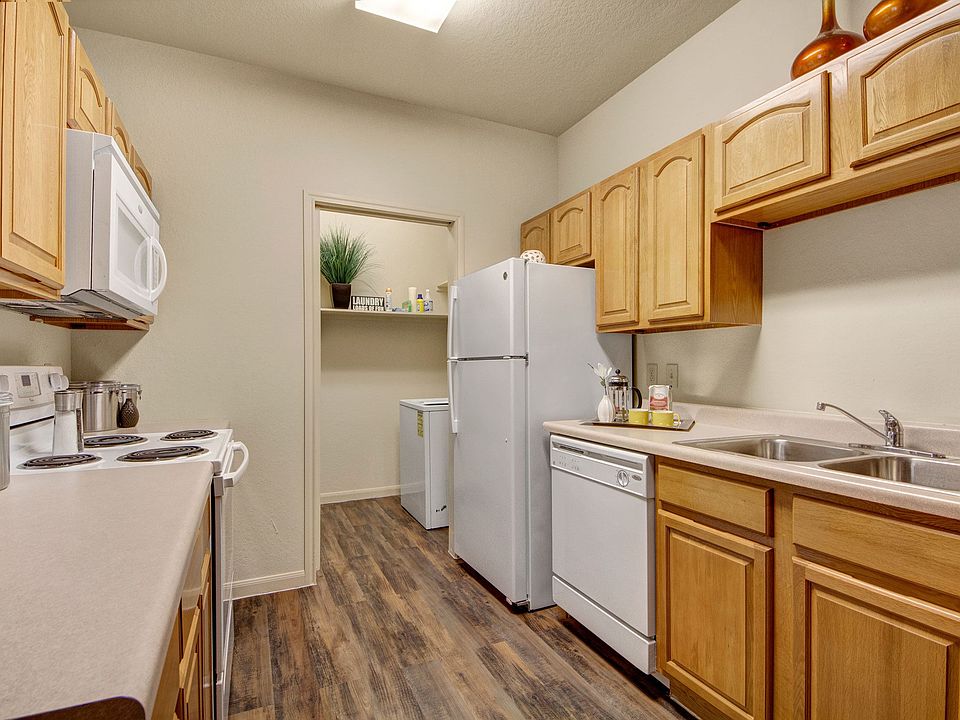 An open kitchen with lots of cabinet storage and easy access to the laundry room
