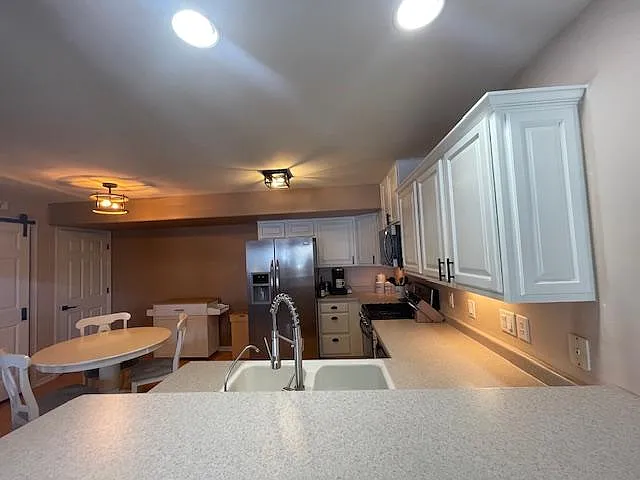 Kitchen and Dining area with stainless steel appliances and breakfast nook