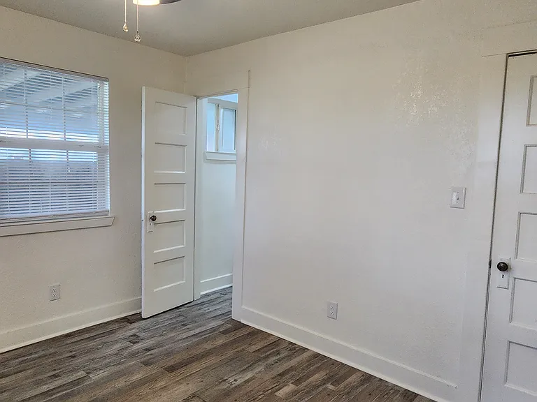 Front bedroom with door to bathroom and closet door.
