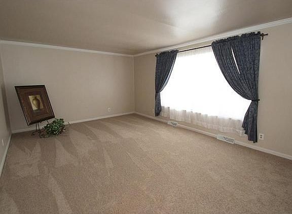 Massive living room with new carpet (2016) and huge front window.