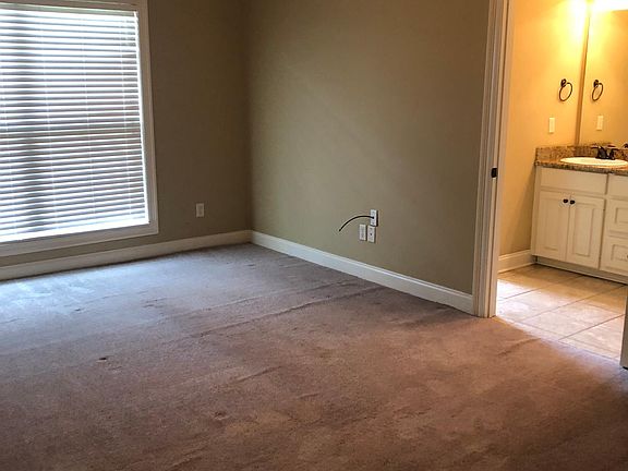 Master bedroom, has carpet, double windows. Entrance into master bathroom
