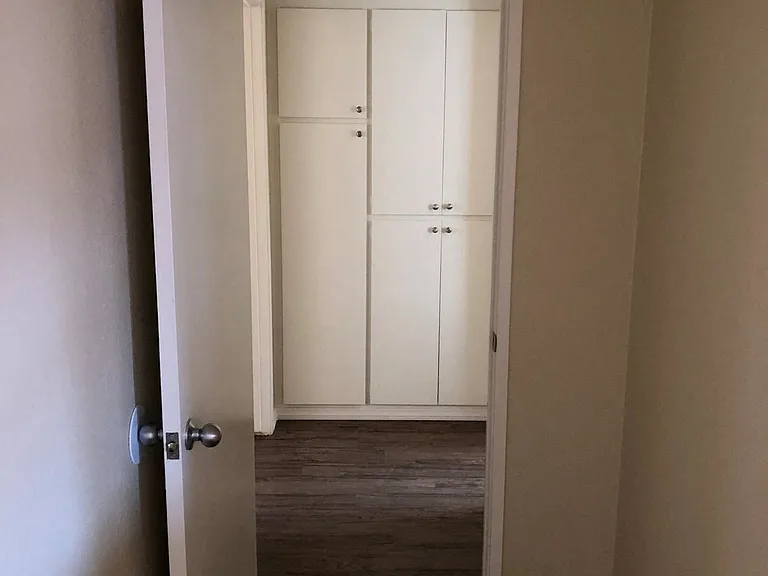 Bedroom hallway with built in cabinets at Plaza Verde Apartments in Escondido, California.