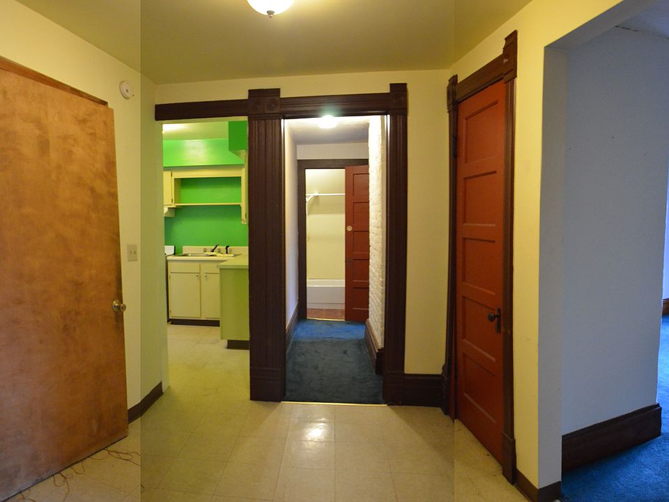 entry space and view of kitchen(repainted) door to attic and