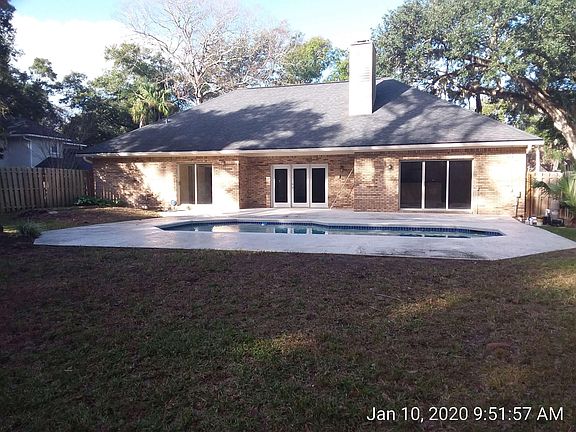 Backyard view showing pool Sliding doors on right open into family room. French doors in center open to living room. Sliding doors on left open to master bedroom.