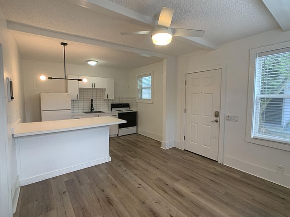 Kitchen viewed from living room; front of kitchen island/dining area